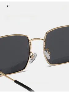 Close-up of comfortable silicone nose pads on classic golden metal square sunglasses