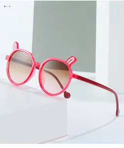 Detail of pink transparent kids sunglasses with cute rabbit ears and gradient lenses