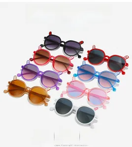 Detailed flat lay of colorful kids sunglasses with cute rabbit ear frames in seven colors