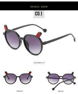 Detail view of black round children's sunglasses with cute bunny ears and purple gradient lenses