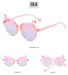 Detail view of pink rabbit-ear children sunglasses with dreamlike gradient lenses