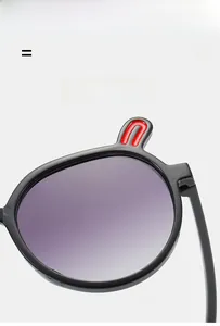 Detail of lightweight black kids sunglasses with red bunny ears and purple gradient lenses