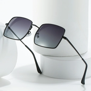 Classic black square frame polarized sunglasses with grey gradient lenses on white pedestal
