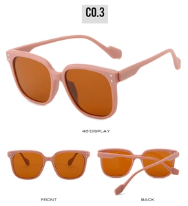 Pink frame children's square sunglasses with silver dot detail and orange lenses