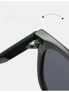 Close-up of the durable silver metal hinge and polished black frame on these sunglasses