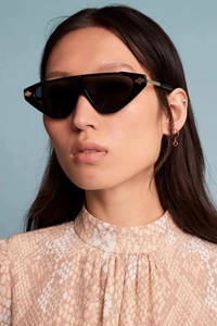 Fashion small frame sunglasses with signature gold arrows and full black lenses on model