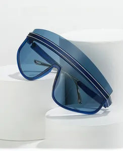 Detail of blue oversized wrap-around sunglasses with stylish white stripes and metal temples