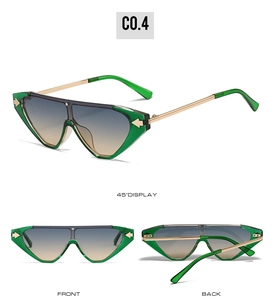 Detailed view of green cat-eye sunglasses with gold metal temples and arrow decor