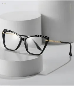 Detail of cat-eye frames with textured embossing and gold chain-pattern metal temples