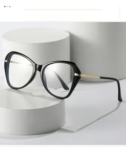 Detailed view of cat eye glasses frame with engraved gold metal temples on a white stand