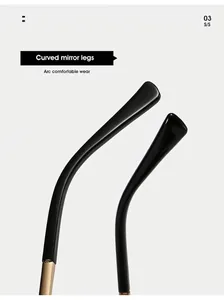Close-up of sleek black curved mirror legs with gold metal hinges and arc design
