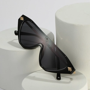 Fashionable black wrap-around sunglasses with golden arrow metal accents on the frame