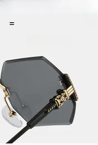 Detail view of gold metal hinge with vintage engraving on polygon sunglasses