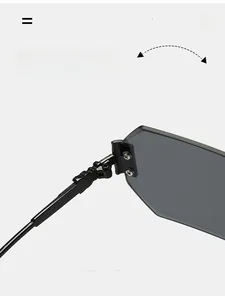 Close-up of durable metal hinges on oversized rimless polygonal sunglasses with grey lenses