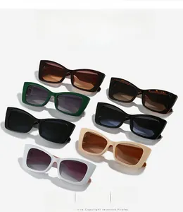 Detailed flat lay of trendy multi-colored cat-eye sunglasses with thick rectangular frames