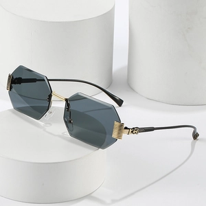 Chic rimless octagonal sunglasses with dark grey lenses and golden metal temples
