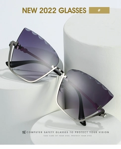 Detail of silver cat-eye sunglasses with rhinestone edges and purple gradient lenses