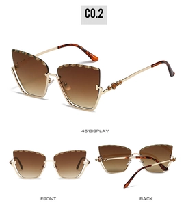Detail view of cat-eye sunglasses featuring metal wave trim and rhinestone temple accents