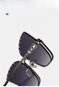 Macro view of cat-eye sunglasses featuring rhinestone accents on dark metal rim