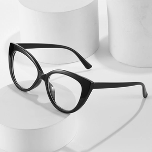Retro black cat-eye glasses frame with clear lenses on a minimalist white pedestal