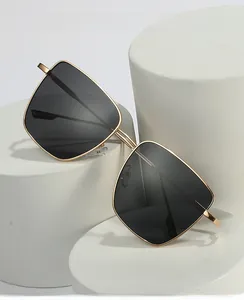 Close-up of square metal frame sunglasses with gray polarized lenses on a white pedestal