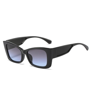 Fashionable cat eye sunglasses with thick black frames and blue gradient lenses