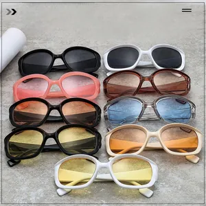 Flat lay of retro oval oversized sunglasses in multiple colors on marble surface