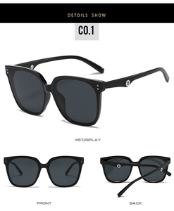 Detail view of square black sunglasses with silver circular hollow hinge decoration