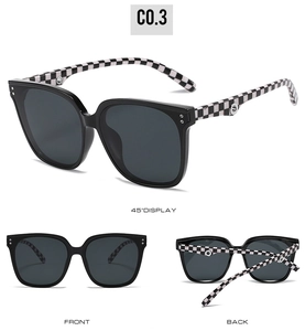 Detail view of square sunglasses with classic black and white checkerboard temples