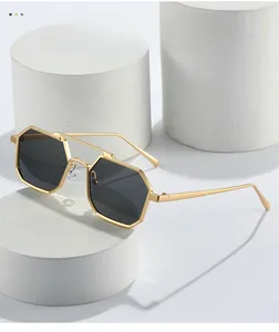 Close-up of vintage octagonal sunglasses with matte gold metal frame and double bridge design