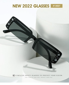 Macro shot of stylish half-frame sunglasses with rhinestone detailing on white podiums