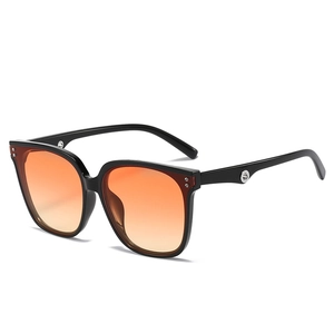 Retro square sunglasses with black frames and orange gradient lenses at 45-degree angle