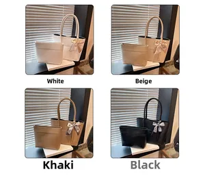 Close-up of stylish lychee grain leather tote bag set with grid bow charm detail