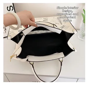 Interior detail of large white tote bag with black letter print and zipper closure