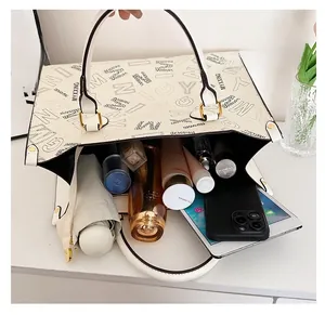 Macro view of a large capacity cream tote bag showing its spacious interior and items