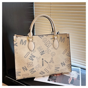 Close-up of cream PU leather tote bag with stylish black lettering and leopard print accents