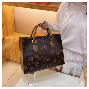 Close-up of MYXXING printed tote bag showing large capacity design and gold hardware