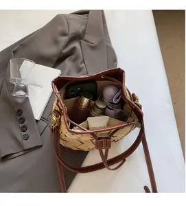 Interior view showing the spacious storage capacity of this woven bucket shoulder bag