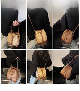 Detail view of woven bucket bag featuring premium leather texture and adjustable strap
