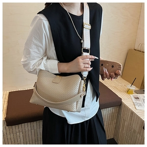 Detail of beige woven soft leather crossbody bag with wide jacquard shoulder strap