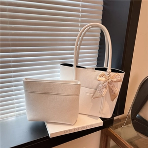 White lychee leather tote bag set with floral silk scarf detail in soft window light