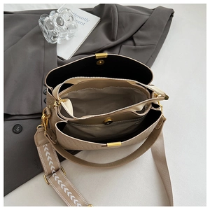 Top view showing the internal three-layer structure and wide patterned strap of this woven bag