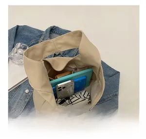 Interior view of the cream canvas tote bag showing large capacity for essentials