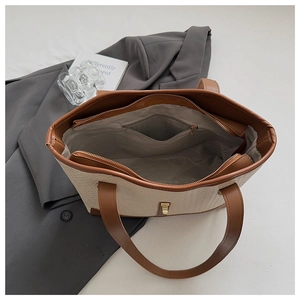 Top view of cream woven tote bag interior with large capacity and zip pocket