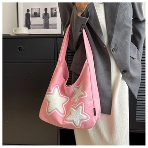 Pink canvas tote bag featuring white star embroidery patches and minimalist side brand label