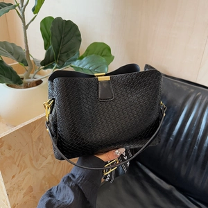Fashionable black woven bucket bag with gold clasp and decorative striped strap
