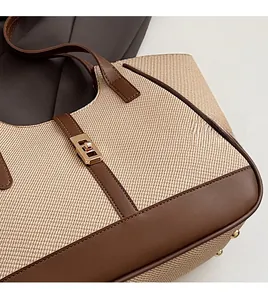 Detail of woven fabric texture and premium brown leather trim with gold metal buckle