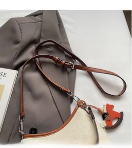 Detail of adjustable leather strap and canvas material with wood horse charm