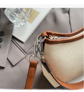 Detail showing contrast canvas and leather texture with polished metal hardware accessories
