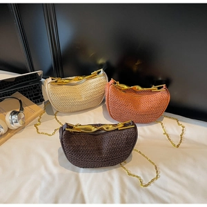 Three woven half-moon bags with artistic golden twisted handles and metal chains
